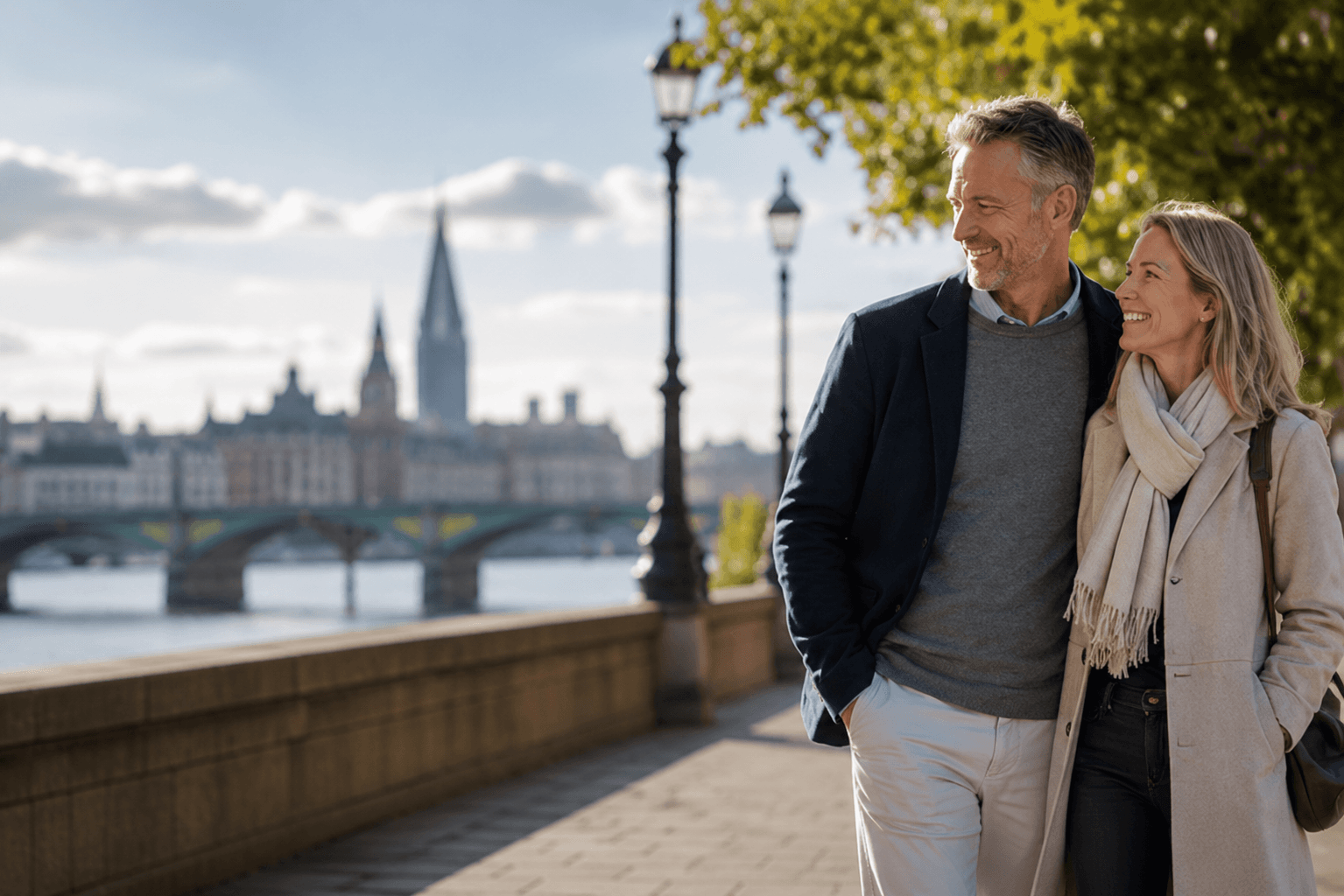 A couple walking together beside the river on an autumn afternoon.